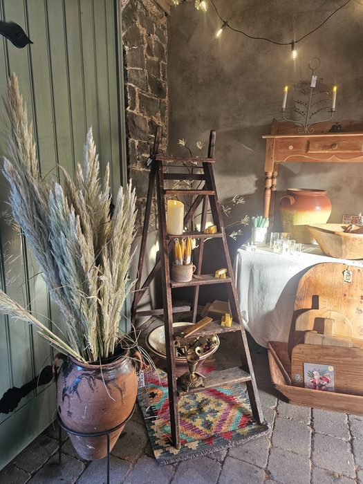 Rustic ladder shelf with candles and vintage goods