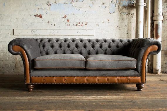 Chesterfield sofa against rustic brick wall