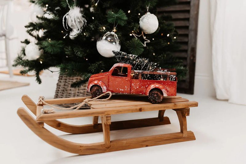 Rustic wooden sled with vintage red truck Christmas decor